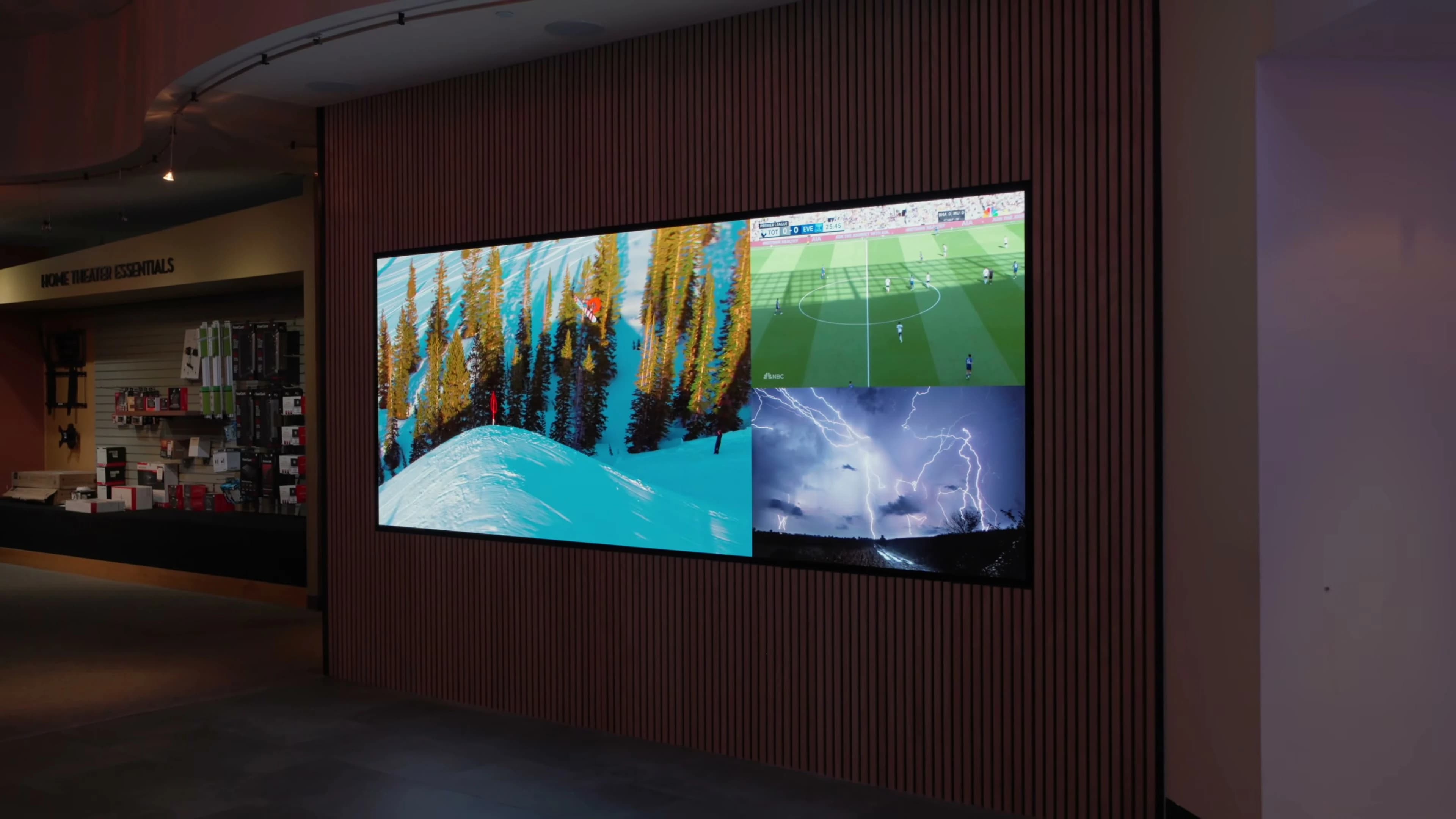 Wide view of Bjorn’s MicroLED wall with home theater essentials retail behind it