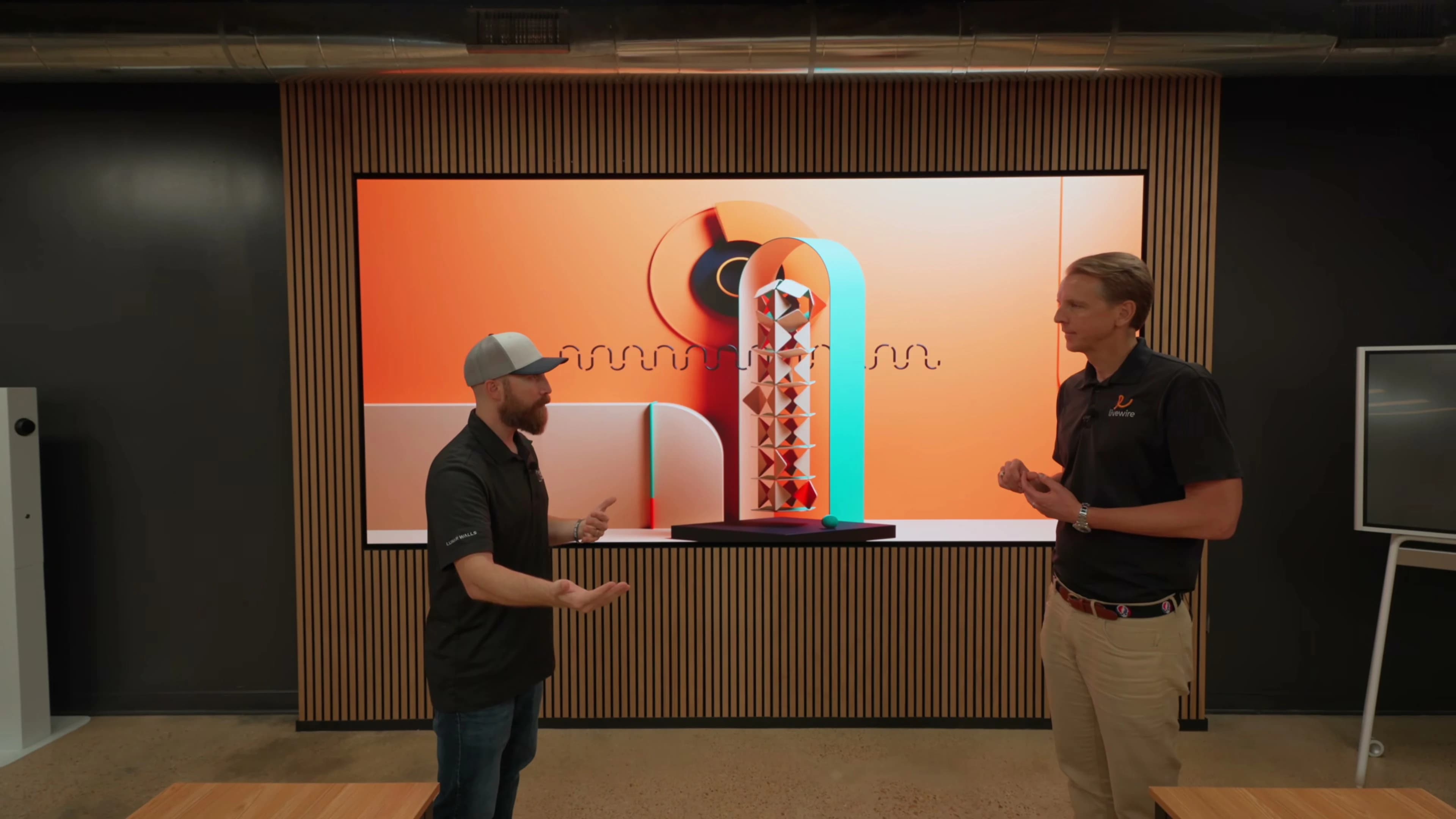 Skyler and Henry discussing the flush MicroLED wall in Livewire’s training center